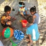 Kids playing on the beach together