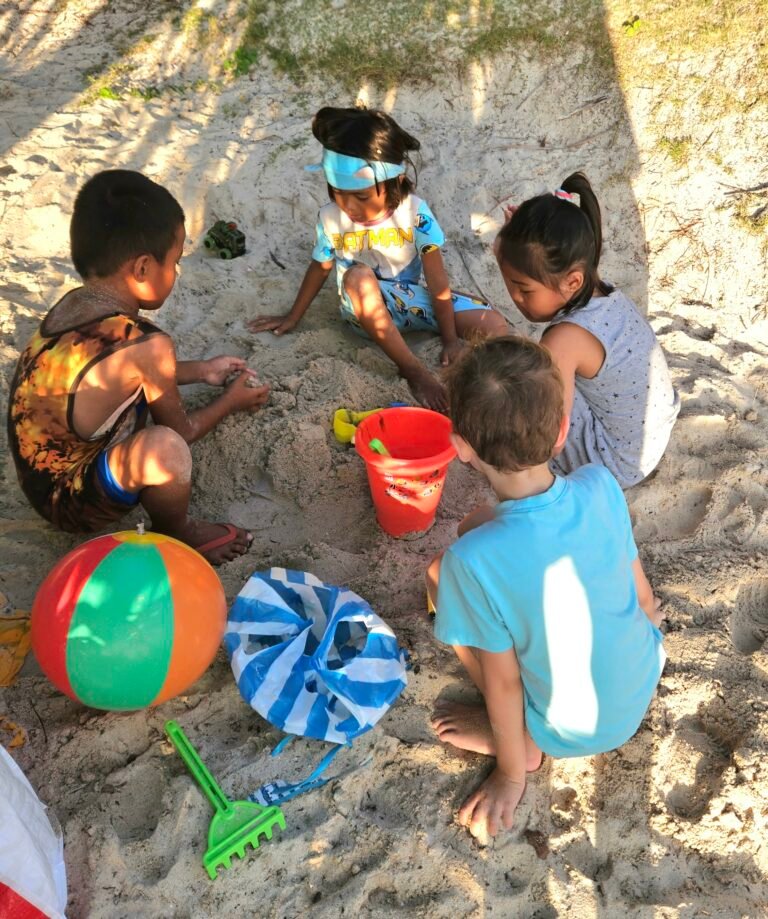 Kids playing on the beach together