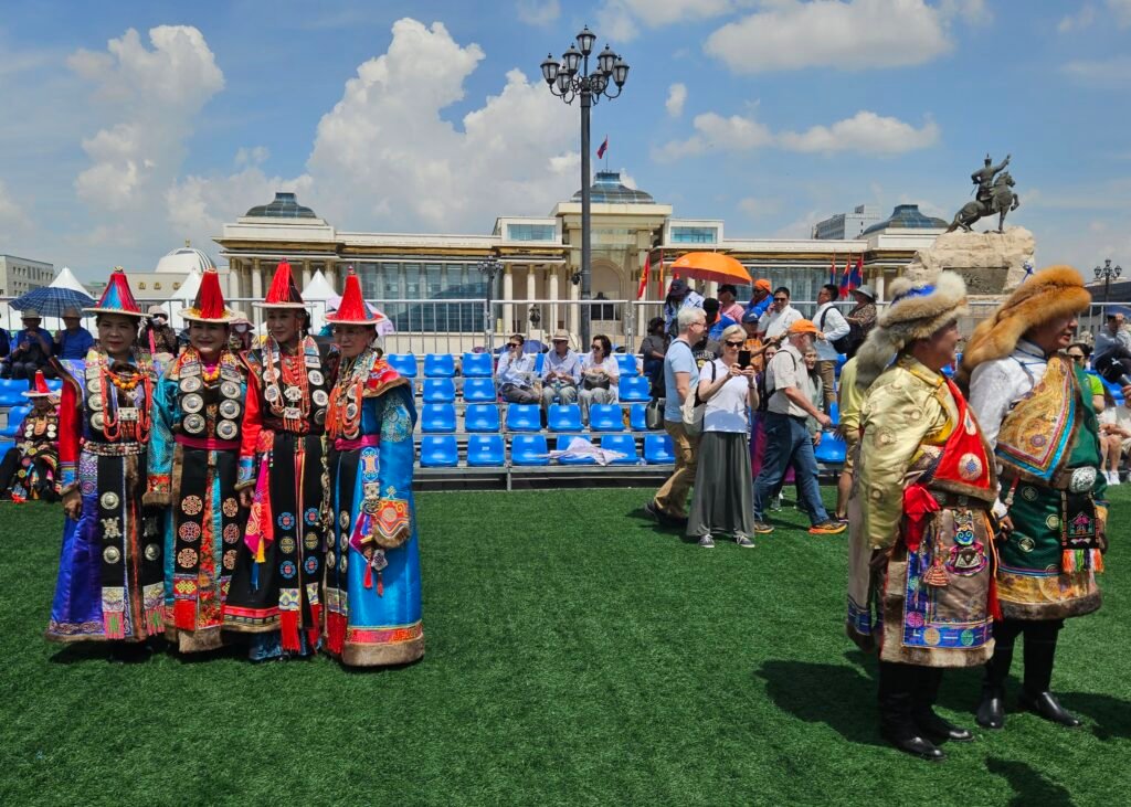 Traditional Mongolian wrestlers in ceremonial dress at Naadam