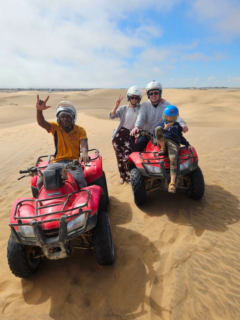 Exploring Namibia with kids: our seven-year-old riding a quad bike through the desert dunes near Swakopmund