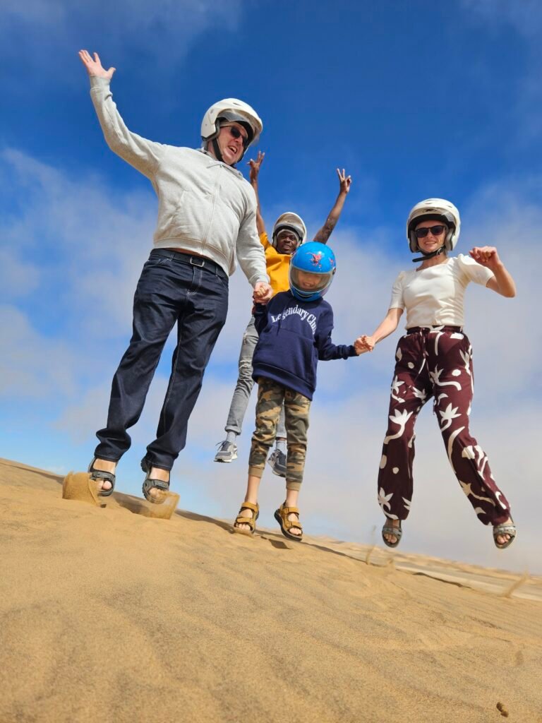 Riding quad bikes over golden sand dunes outside Swakopmund, Namibia