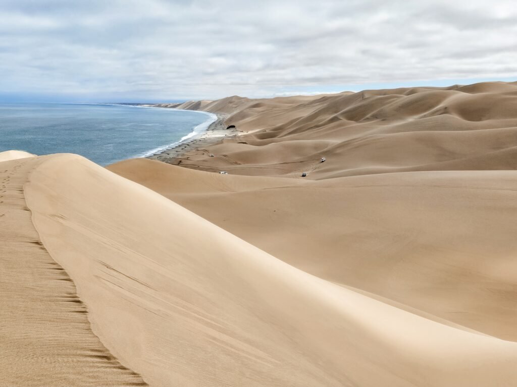 Steep sand dunes plunging into the ocean at Sandwich Harbour