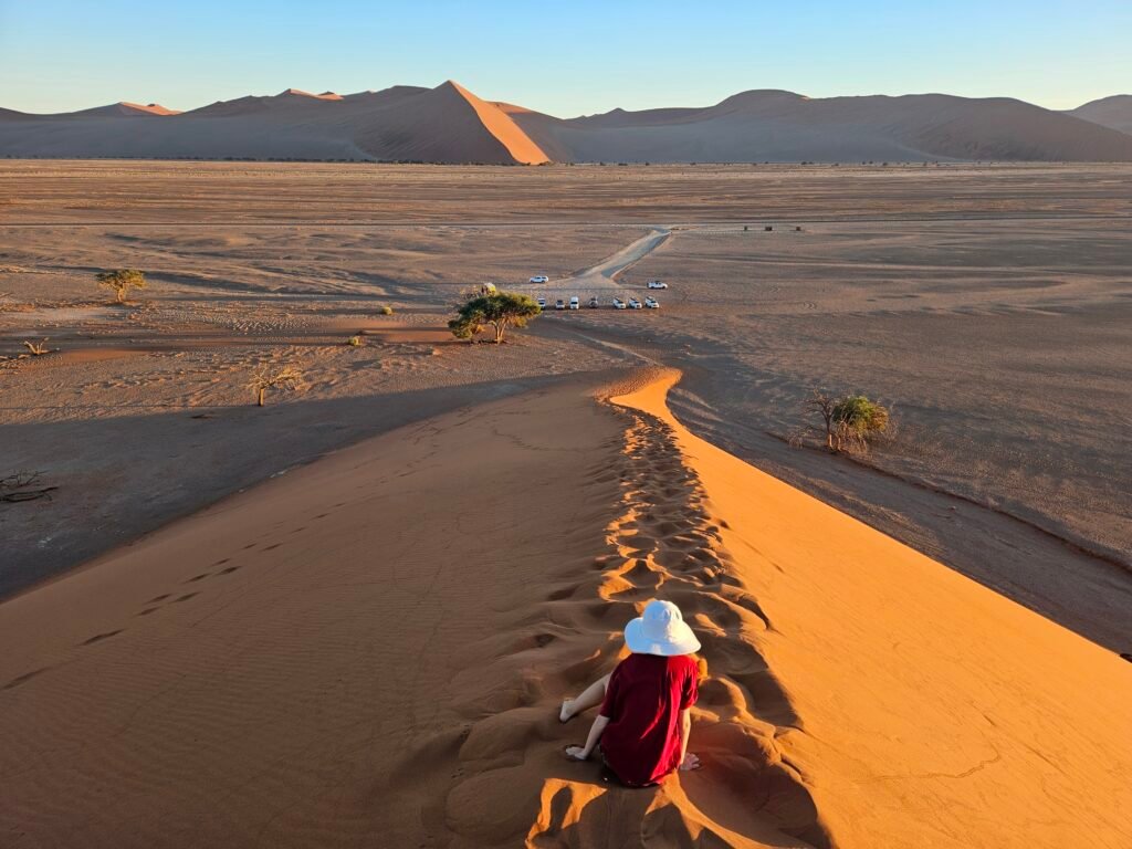 Hiking up Dune 45 in the Namib Desert at sunrise
