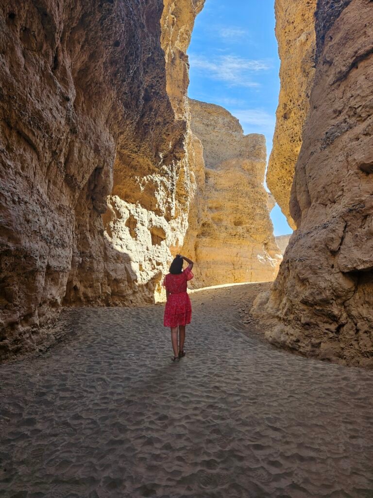 Family exploring the layered rock formations of Sesriem Canyon