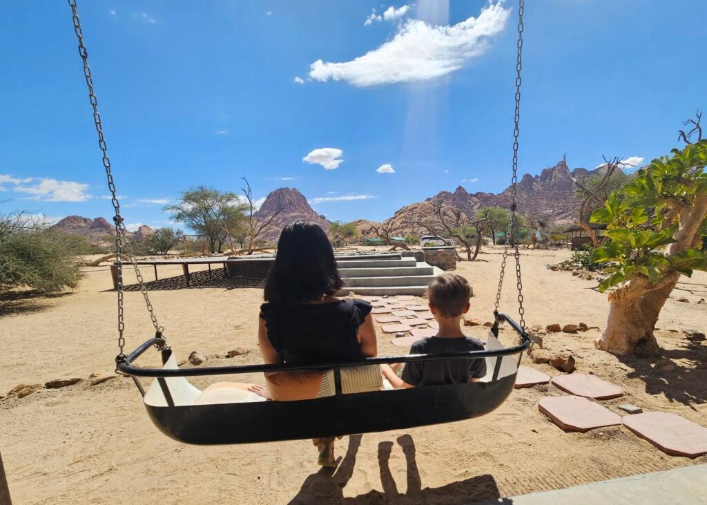 Family exploring the granite peaks of Spitzkoppe, Namibia