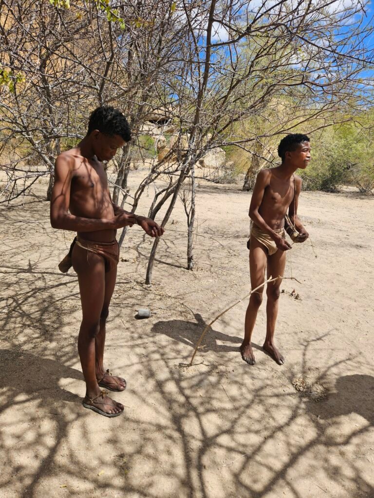 San community performing traditional songs and dance for visitors