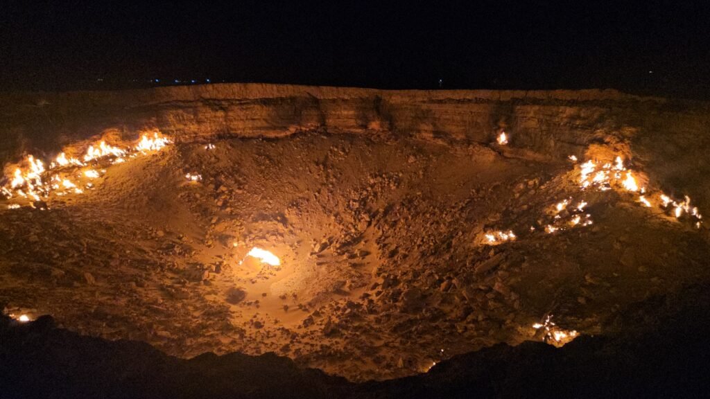 Family standing at the edge of the burning Darvaza Gas Crater