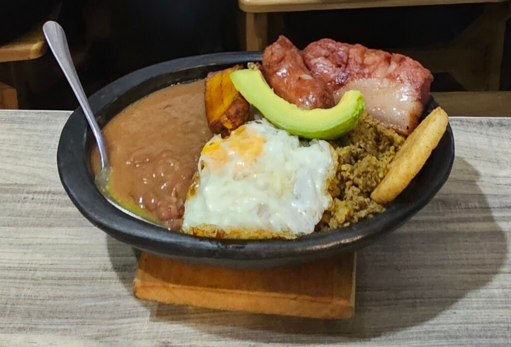 Bandeja paisa, a traditional Colombian platter with beans, rice, egg, avocado and meats