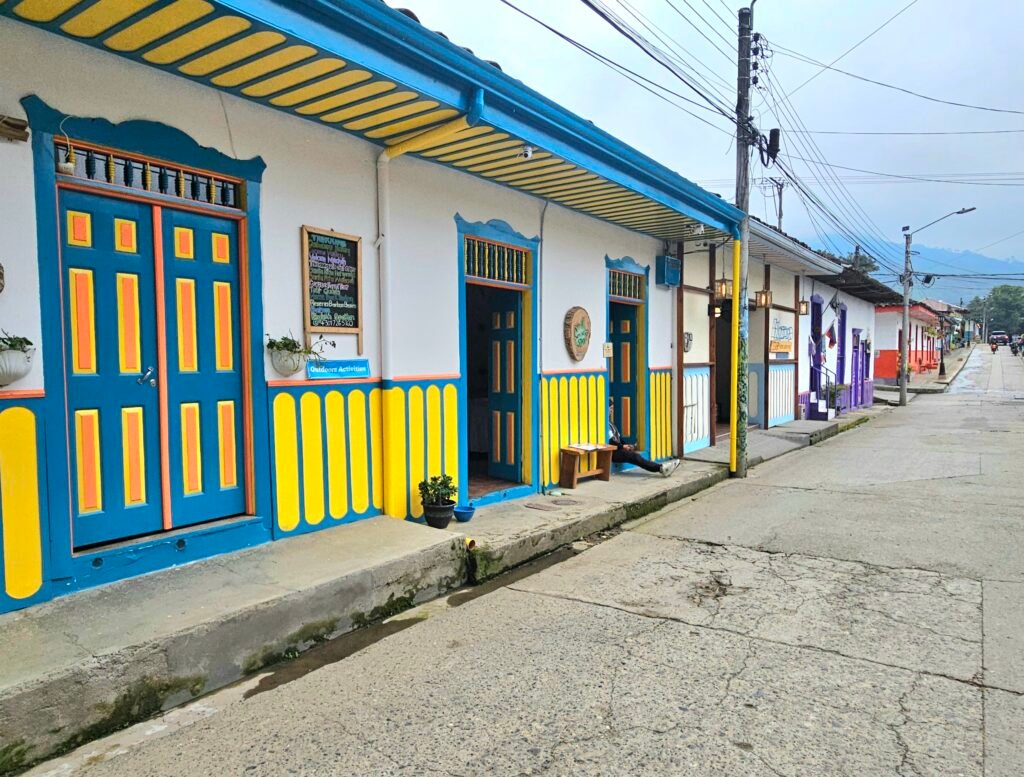 Colourful blue and yellow shopfronts on a street in Salento