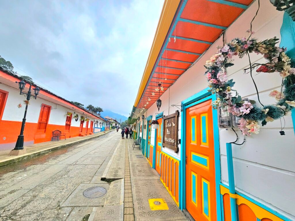 Colourful orange and white buildings lining the main street of Salento
