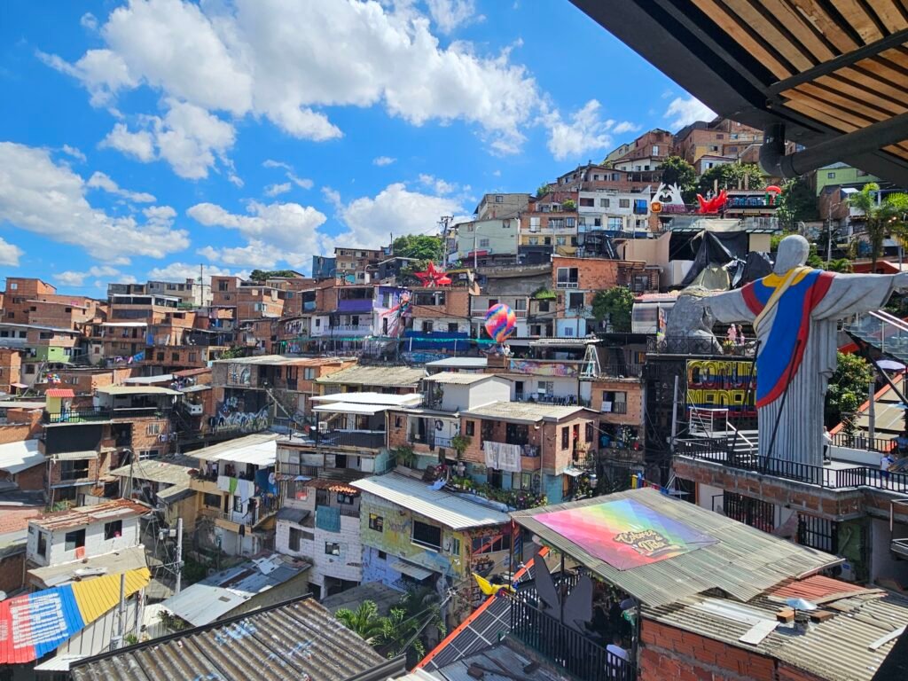 Aerial view of Comuna 13's colourful hillside houses and murals in Medellín