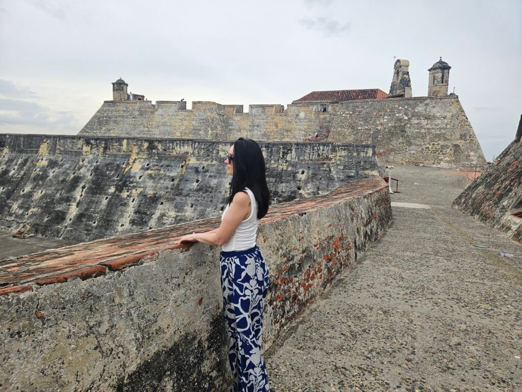 Woman looking out over the historic walls of Cartagena