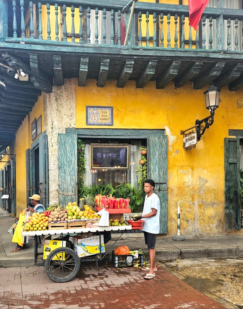 Street vendor selling fruit from a cart in Cartagena's old town