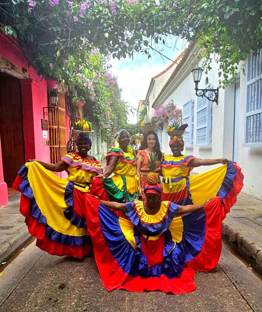 Palenqueras in traditional dress posing with a visitor in Cartagena's old town