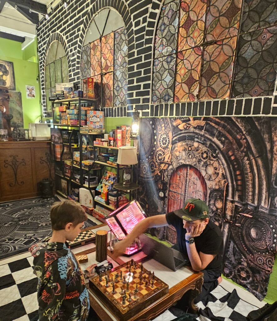 Family playing a board game at High Rollers Café in Antigua Guatemala