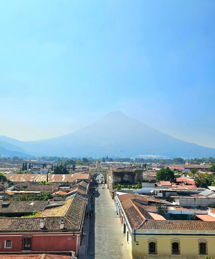 Family standing beneath the Santa Catalina Arch in Antigua Guatemala