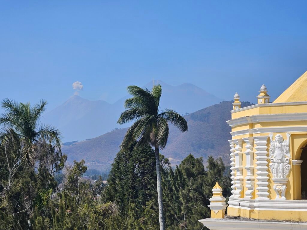 Colourful colonial street in Antigua Guatemala with a volcano in the background