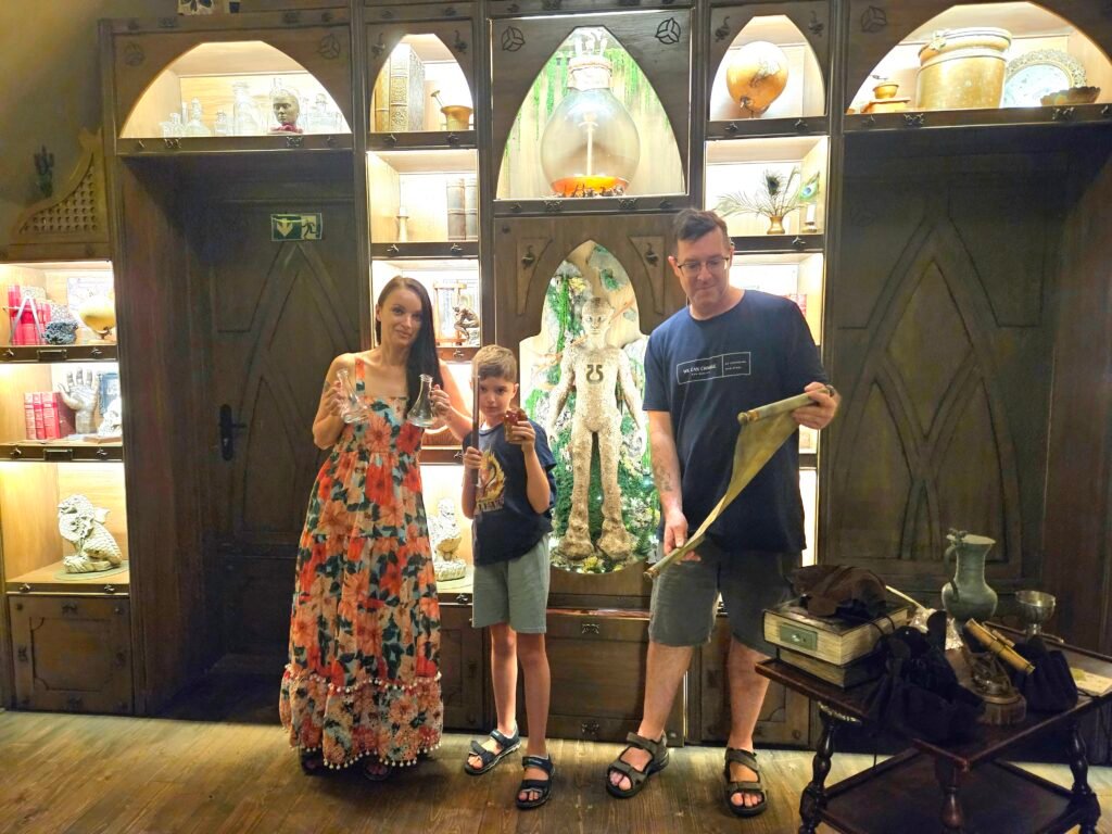Family solving clues in the Alchemy-themed escape room at MindMaze in Prague