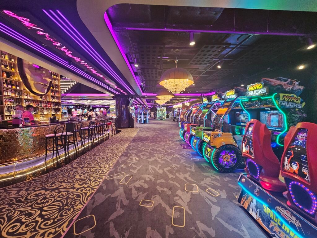 Neon-lit bar and arcade racing games inside LEVELS Prague entertainment centre