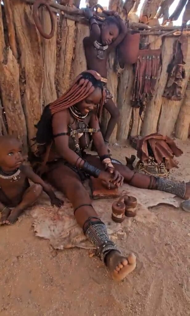 Himba woman in traditional dress showing jewellery and hairstyle