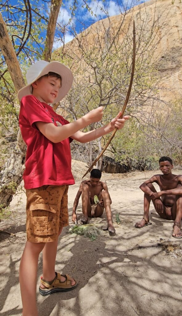 San community members demonstrating traditional hunting techniques