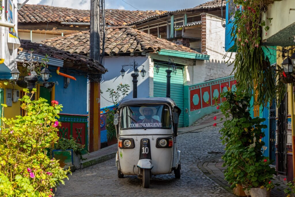 Colourful tuk-tuk on a cobblestone street in Guatapé