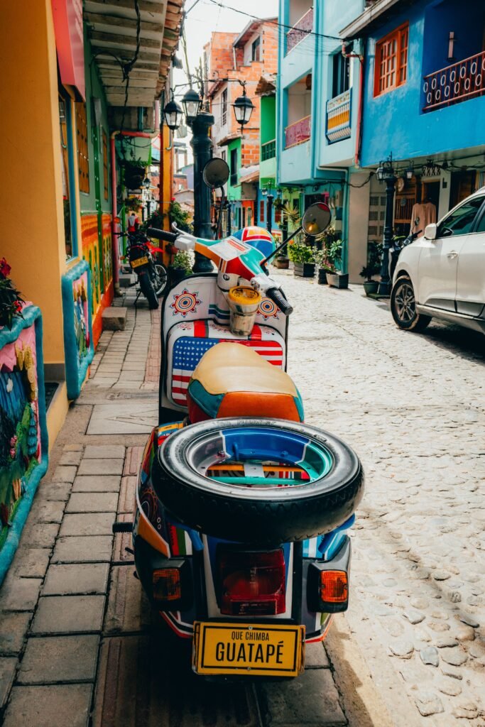 Decorated moto-taxi parked among the colourful zócalo houses of Guatapé