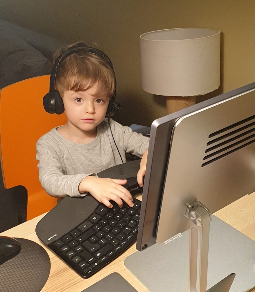 Laptops and travel electronics packed for long-term travel as a digital nomad family