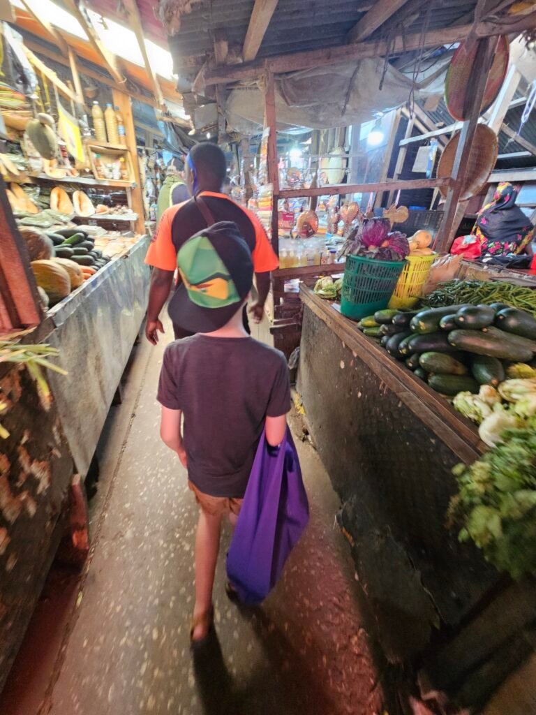 Walking through Darajani Market in Stone Town with our son