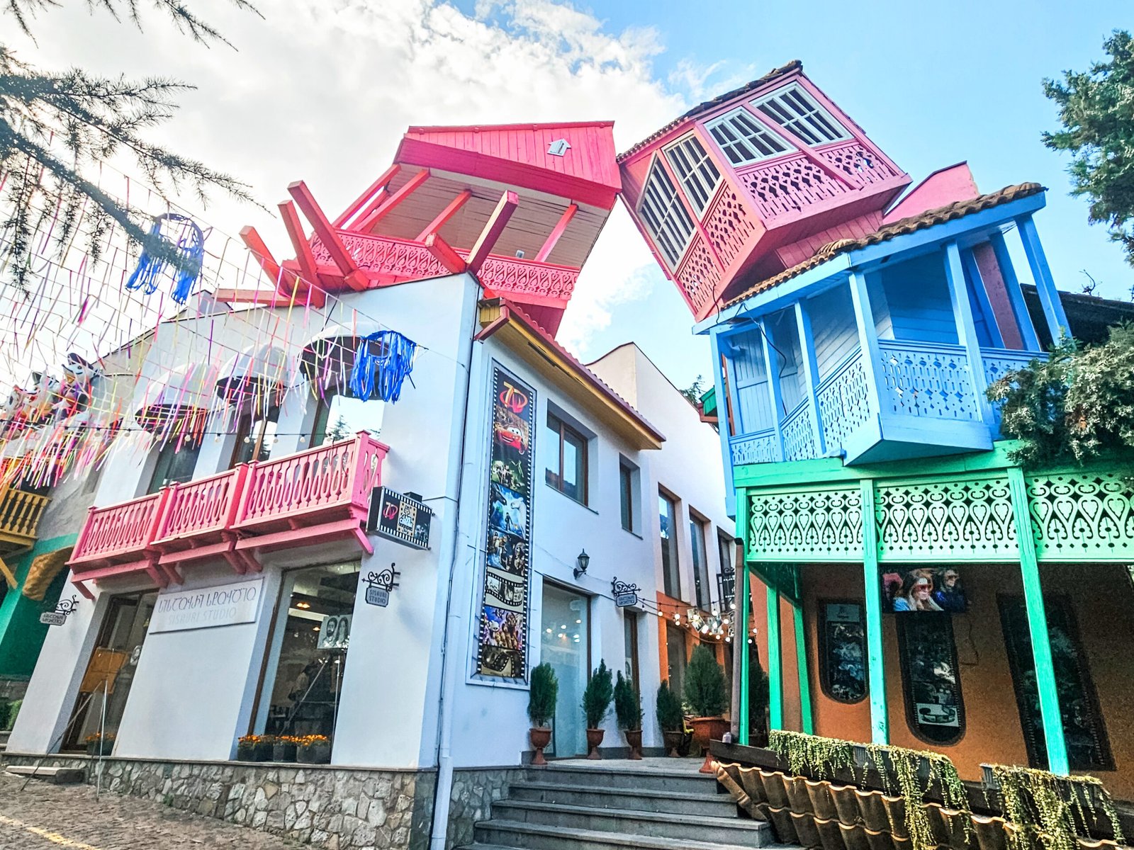 Colourful tilted wooden balconies with hanging decorations at Mtatsminda Park in Tbilisi